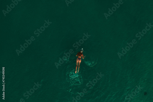 Aerial top nature view above green turquoise Thracian sea Greece Ellada. Beautiful woman bikini