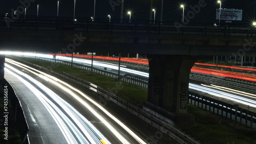 Light trails from cars at night on a multi-lane highway in madrid