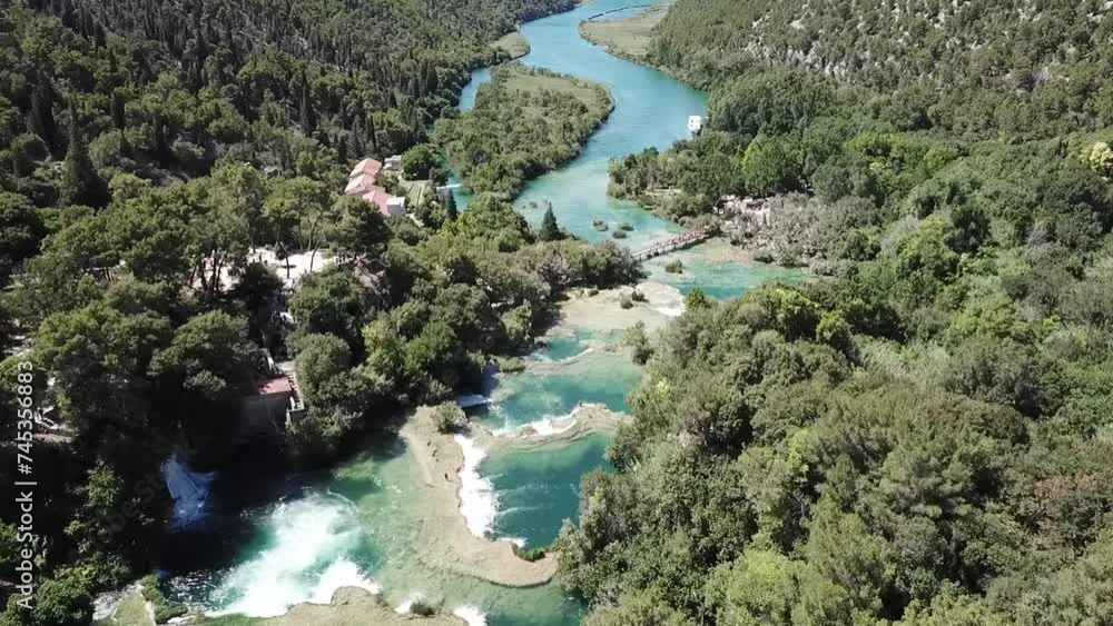 Aerial shot of a beautiful waterfall between trees on a sunny day, above Karka Falls, Croatia Aerial shot of a beautiful waterfall between trees on a sunny day, above Karka Falls, Croatia
