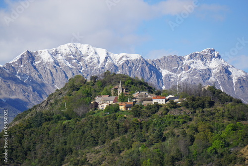 view of the village of avan  on perched on the hill in the mountains in the southern alps  france