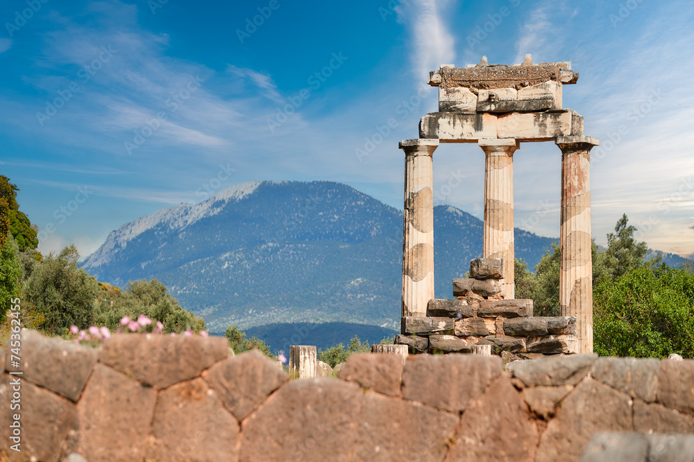 Greek history theme: Tholos with Doric columns at the sanctuary of Athena Pronoia temple ruins in ancient Delphi, UNESCO World Heritage Site, Greece.