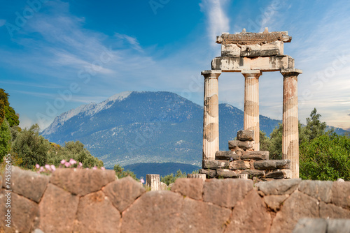 Greek history theme: Tholos with Doric columns at the sanctuary of Athena Pronoia temple ruins in ancient Delphi, UNESCO World Heritage Site, Greece.