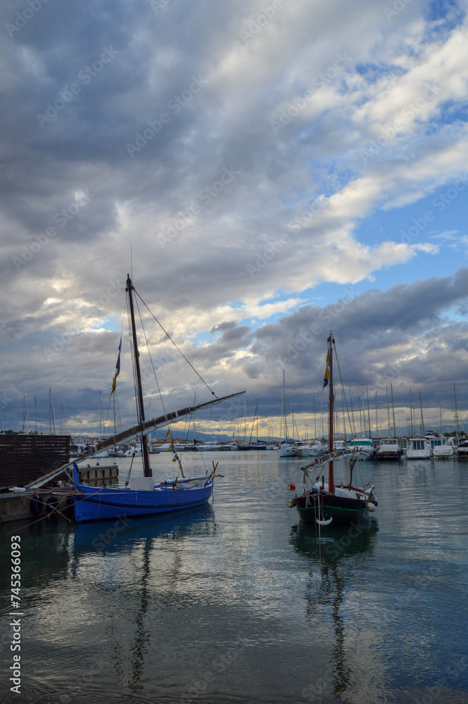 Two old Latin fishing boats with a cloudy sky