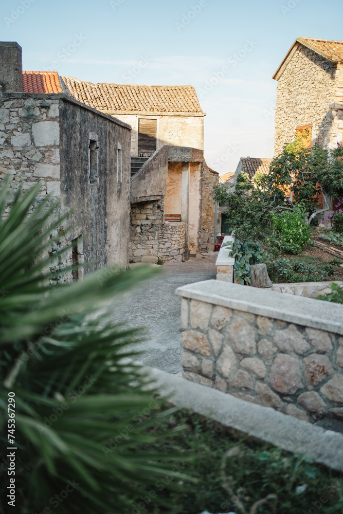 Narrow medieval street with stone houses in Old Town, Biograd na Moru in Croatia