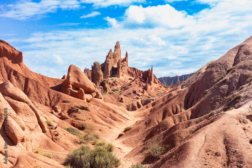 landscape of Skazka canyon on Issyk-Kul lake. Rocks Fairy Tale famous destination in Kyrgyzstan. Mountain like great wall of china and Rainbow Mountains of Danxia or Antelope crevice USA. Central Asia landscape of Skazka canyon on Issyk-Kul lake. Rocks Fairy Tale famous destination in Kyrgyzstan. Mountain like great wall of china and Rainbow Mountains of Danxia or Antelope crevice USA. Central Asia