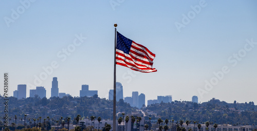 USA Flag flying with Los Angeles skyline in background