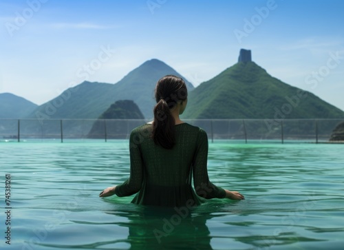 Woman Relaxing in the Waters Overlooking a Skyline at Dusk