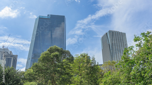 Photographs of locations, views of buildings, hundreds of stories high in the capital. It's already developed. The blue building next to it is under construction. The big trees are green below.