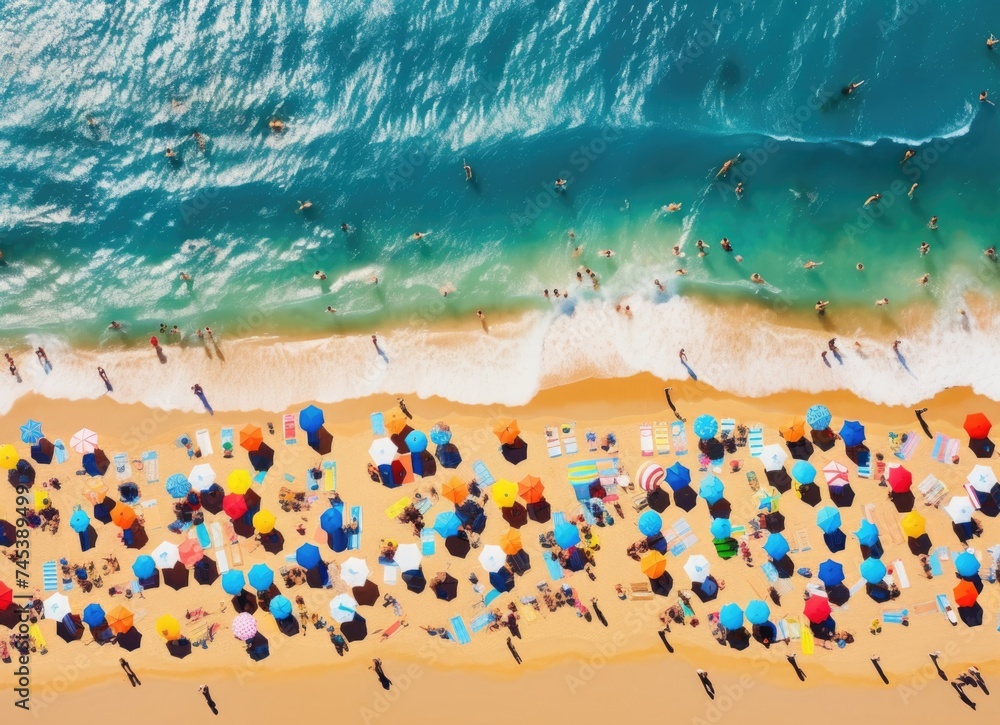 Aerial view of crowded beach with umbrellas.