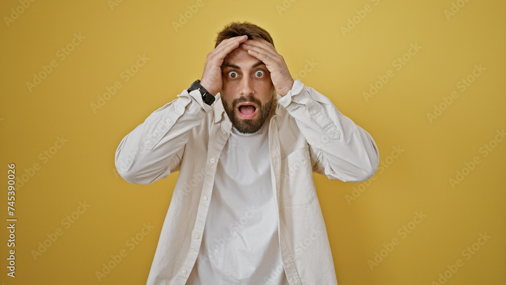 Wow! cheerful young hispanic man surprisingly stands isolated, his hands expressing amazement; a portrait framed by a bold yellow background. Wow! cheerful young hispanic man surprisingly stands isolated, his hands expressing amazement; a portrait framed by a bold yellow background.