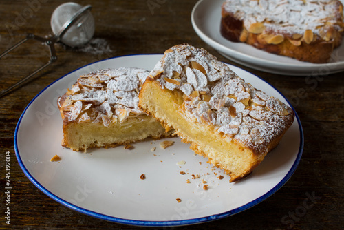 Sweet bread cut into slices and spread with a thin fruit glaze and topped with an almond spread