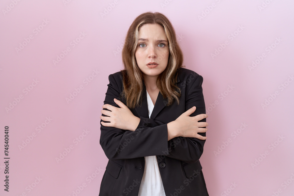 Young caucasian business woman wearing black jacket shaking and freezing for winter cold with sad and shock expression on face Young caucasian business woman wearing black jacket shaking and freezing for winter cold with sad and shock expression on face