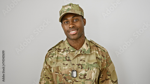 Bild auf Leinwand Smiling african american soldier in camouflage uniform posing against an isolated white background