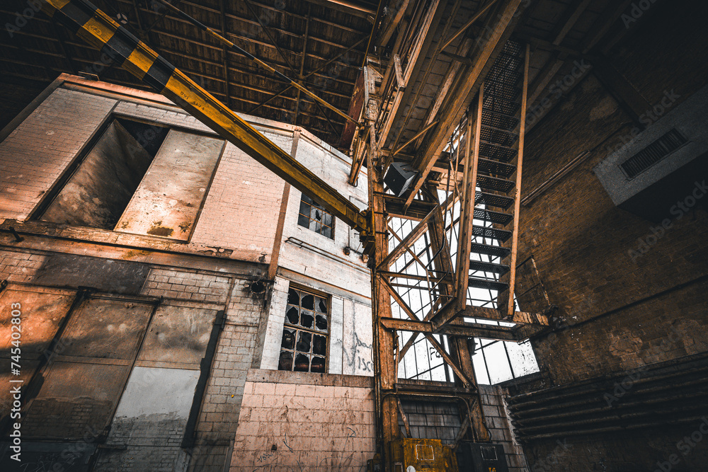 Roof girders and stairs in an old abandoned industrial hall Roof girders and stairs in an old abandoned industrial hall