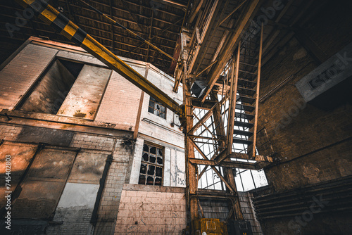Roof girders and stairs in an old abandoned industrial hall 