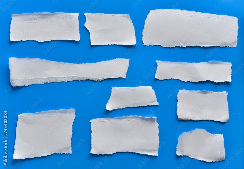 Various torn pieces of white paper, stickers on a blue background. Various torn pieces of white paper, stickers on a blue background.