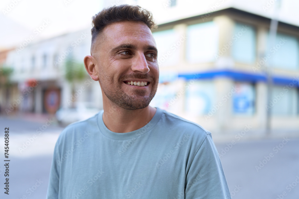 Young hispanic man smiling confident looking to the side at street Young hispanic man smiling confident looking to the side at street