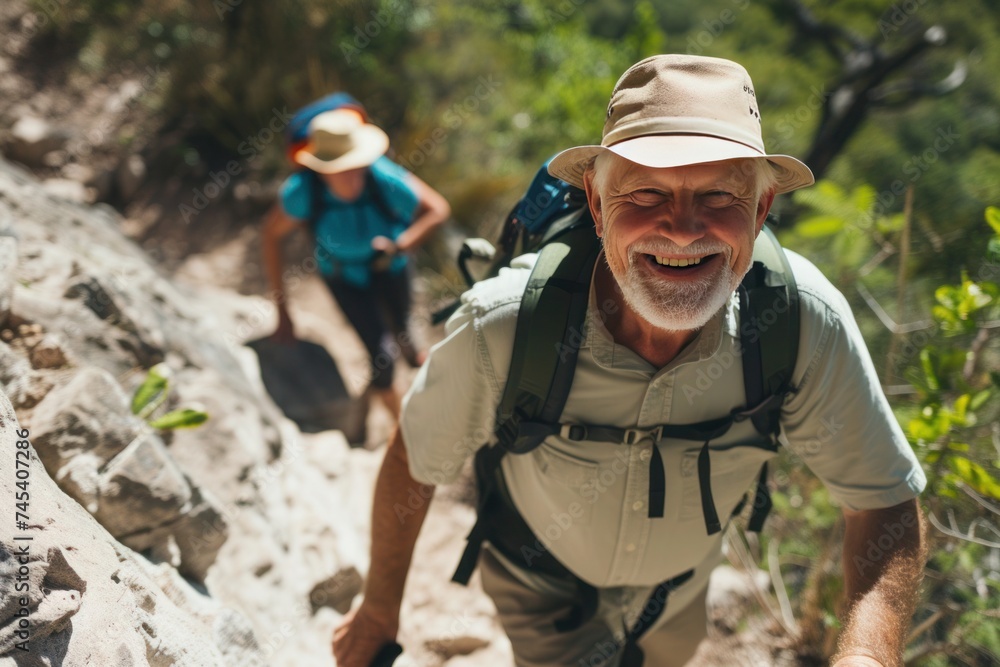 A couple in hats smiling while hiking up a mountain, enjoying outdoor recreation