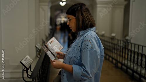 Photography Young beautiful hispanic woman visiting crypt reading brochure at Imperial Crypt