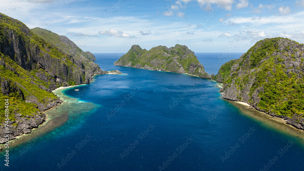 Islands in El Nido. Tapiutan and Matinloc surrounded by blue sea. Palawan. Philippines.