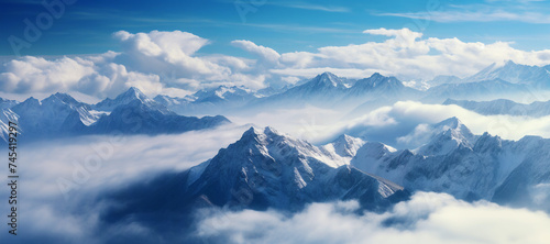 Breathtaking Mountain Panorama with Snow-Covered Peaks of a Alpine Mountain Massif with Blue Sky and Clouds - Landscape of Majestic Mountains with Snow