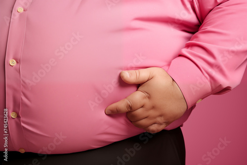 Morbidly obese adult man waist, close up, overweight person. Diabetes and cardiovascular risks, sedentary lifestyle photo