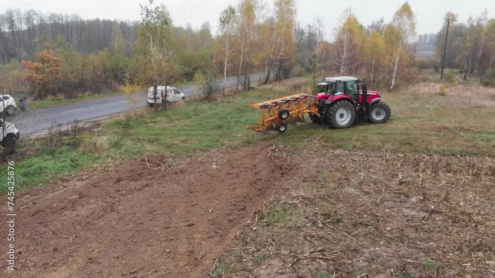 Tractor plowing the field in Ukraine Tractor plowing the field in Ukraine