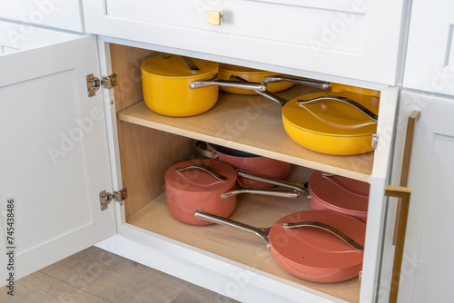 Canvas Print Colorful cookware in kitchen cabinet