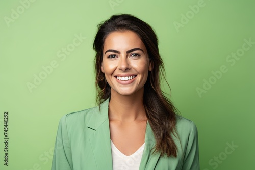 Portrait of happy smiling beautiful young businesswoman, over green background