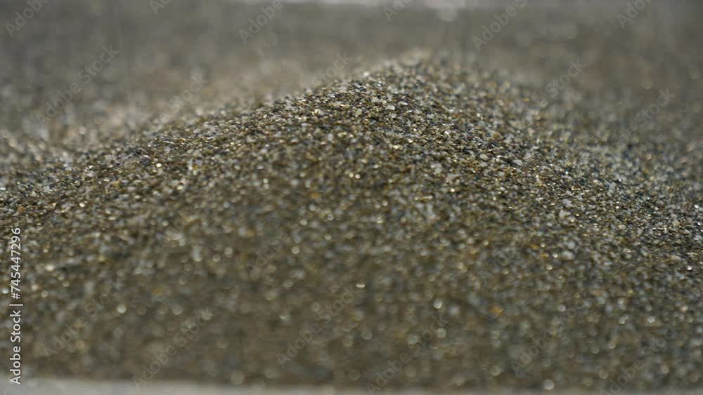 Searching through the huge amounts of gold dust precious metals. Pouring the gold dust into the pan for precious metal extraction. Looking for expensive precious metal material. Pile of gold dust Searching through the huge amounts of gold dust precious metals. Pouring the gold dust into the pan for precious metal extraction. Looking for expensive precious metal material. Pile of gold dust