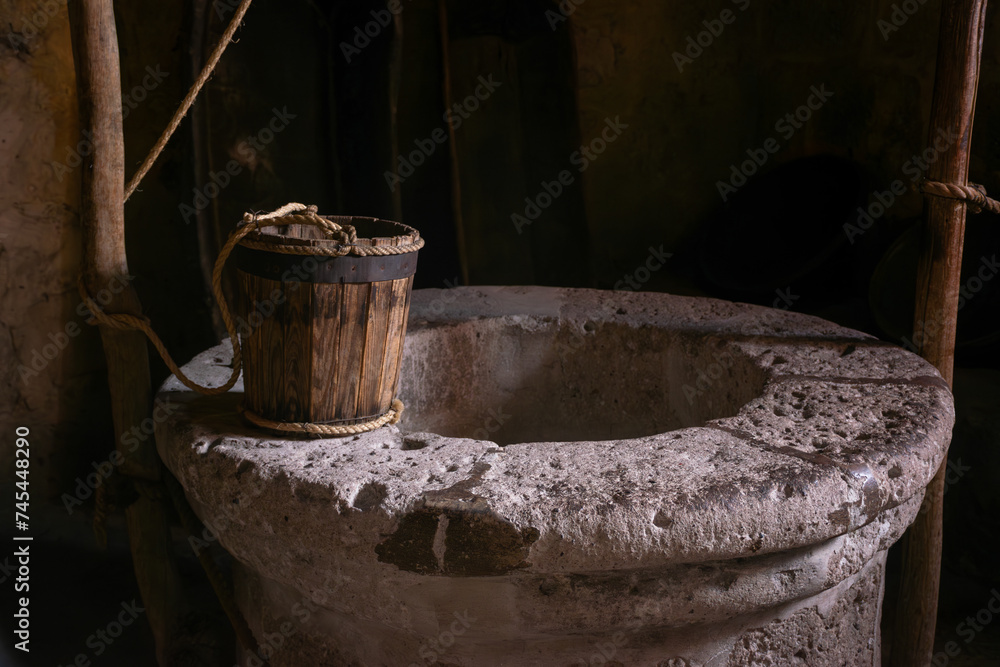 Antique wooden bucket on historic monastery kitchen   - obrazy, fototapety, plakaty 