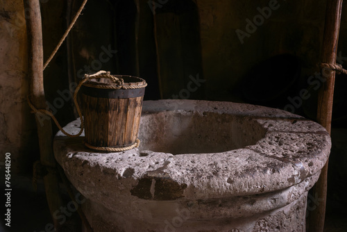 Antique wooden bucket on historic monastery kitchen 