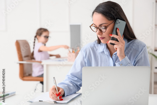 Working mother with her lit...