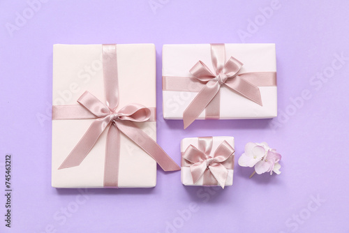 Gift boxes and beautiful hydrangea flowers on lilac background. International Women's Day © Pixel-Shot