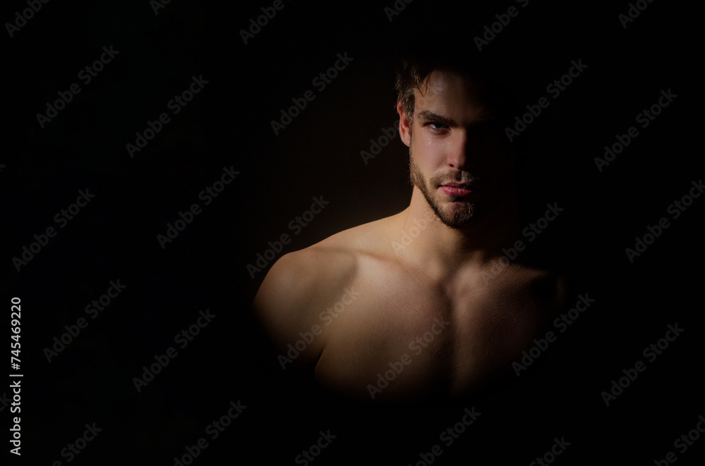 Man studio portrait. Silhouette portrait of a young man. Man in shadows. Muscular sexy body silhouette in dark. Young male face with shadow on studio lowkey. Studio shot of mans models faces. Man studio portrait. Silhouette portrait of a young man. Man in shadows. Muscular sexy body silhouette in dark. Young male face with shadow on studio lowkey. Studio shot of mans models faces.