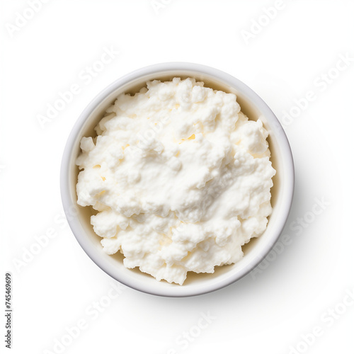 A bowl filled with cottage cheese is placed on a clean white background, top view, isolated