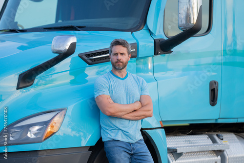 Men driver near lorry truck. Man owner truck driver. Millennial trucker. Trucking owner. Transportation industry vehicles. Handsome man posing in front of truck.