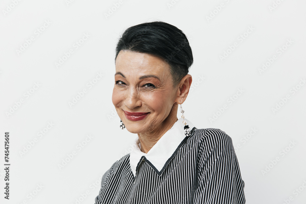 Happy Asian woman with short hair in black and white striped shirt smiling at camera portrait Happy Asian woman with short hair in black and white striped shirt smiling at camera portrait