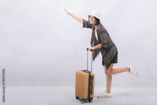 Portrait of Young Asian Woman carrying suitcase for vacation