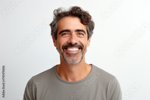 Portrait of a happy middle-aged man with gray hair and beard smiling at the camera on a white background