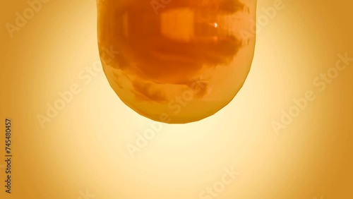 3d animation of dripping yellowish  fish oil photo