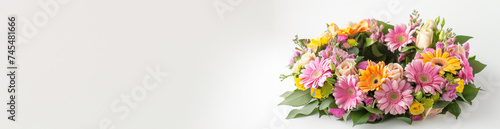 Vibrant spring flower arrangement with pink gerberas  yellow roses  and mixed blooms on a white background with ample copy space for text