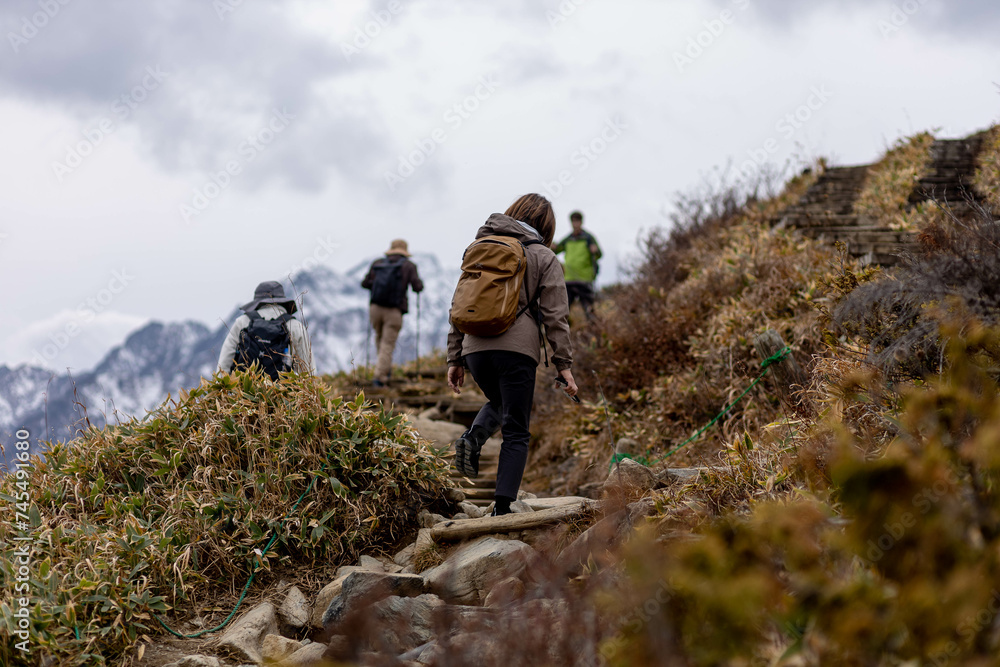 Hakuba, Japan - 4 November 2023 : Hikers walking on a rocky surface on a moutain at Hakuba, Japan.