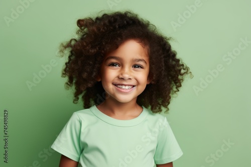 happy african american little girl in green t-shirt on green background