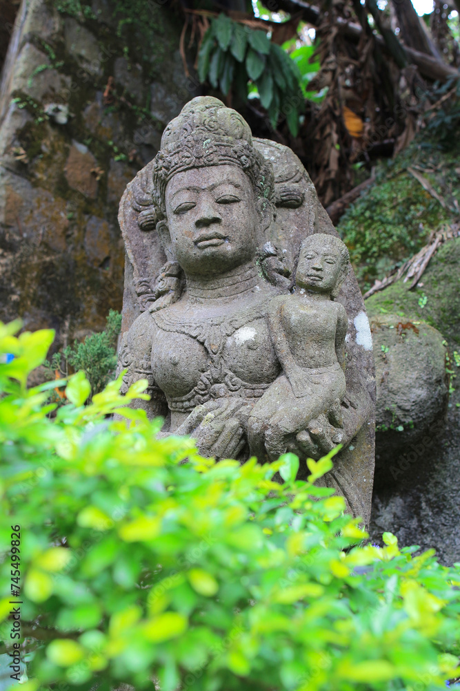 an old stone Buddha statue at nature