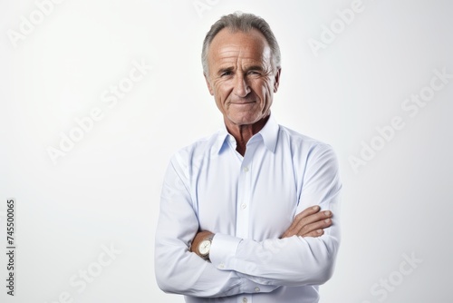 Portrait of senior man with arms crossed. Isolated on white background.