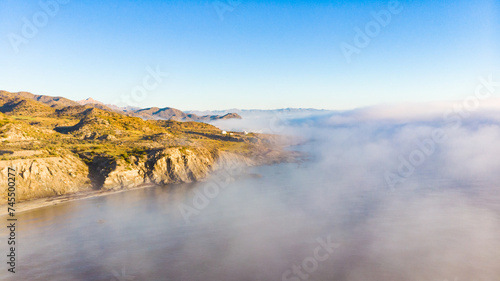 Sea with morning fog over water.