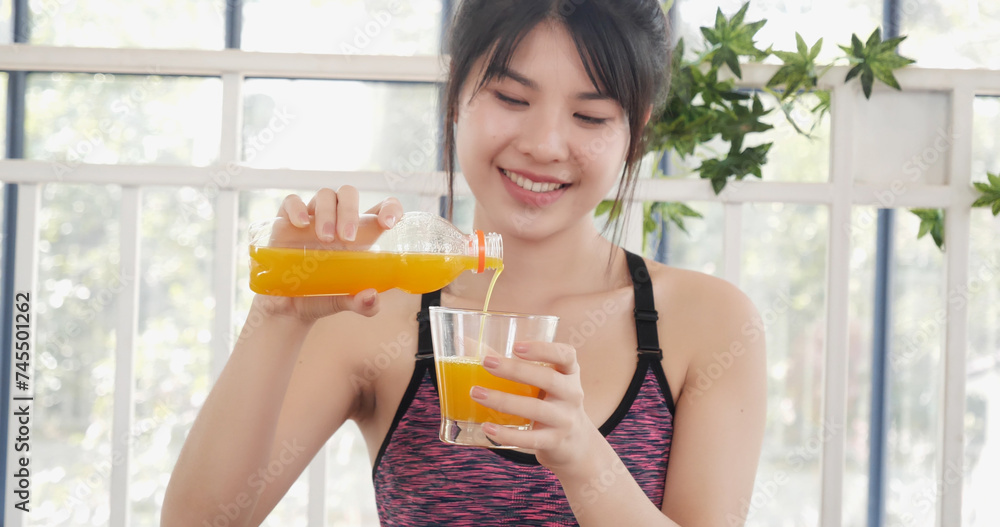 Asian women smile laugh look at camera health care home fitness lifestyle. Women hands holding cold orange juice fresh fruit cool drinking. Beautiful female pouring orange juice from cocktail bottle Asian women smile laugh look at camera health care home fitness lifestyle. Women hands holding cold orange juice fresh fruit cool drinking. Beautiful female pouring orange juice from cocktail bottle
