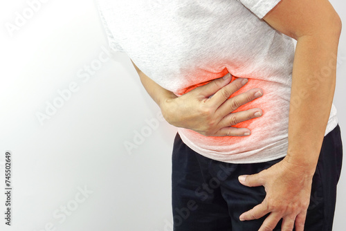 Asian woman suffering from stomachache. Chronic gastritis, menstruation and health concept. photo