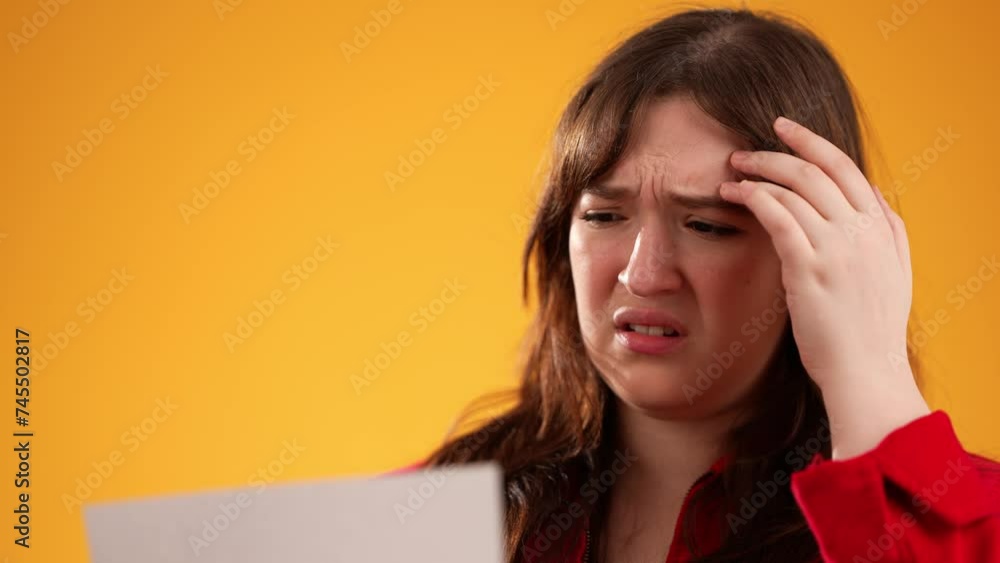 Portrait of angry stressed businesswoman opening envelope reading bad news in mail letter. Frustrated about high bills dismissal notice, bank debt, tax invoice or mistake isolated on yellow background Portrait of angry stressed businesswoman opening envelope reading bad news in mail letter. Frustrated about high bills dismissal notice, bank debt, tax invoice or mistake isolated on yellow background